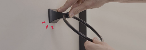 Hands snapping bath hardware into place