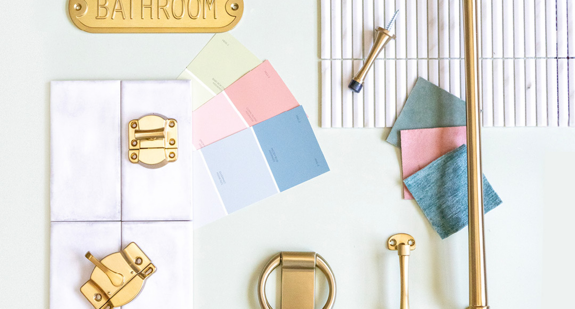 Decorative items including a gold lock, pastel-colored square blocks, and small gold objects on a white surface.