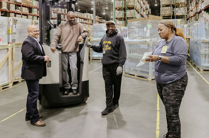 Employees talking in a warehouse